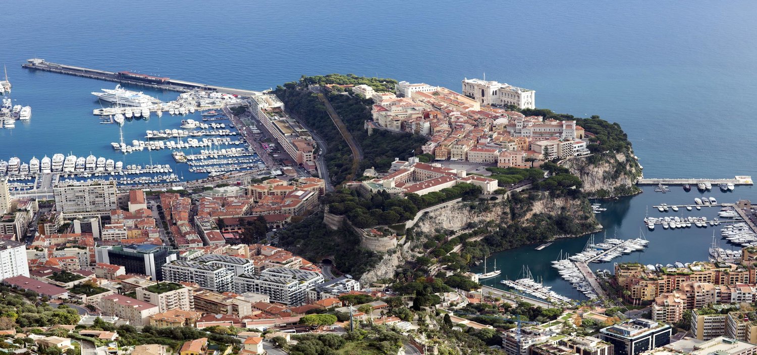 Monaco and the French Riviera yacht charter itinerary. Arial view of Monaco and its super luxury yachts for charter
